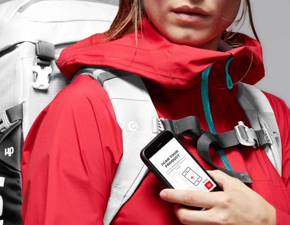 Woman in red sports gear holding smartphone